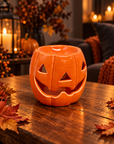 Orange Pumpkin ceramic wax melt burner in a cosy Halloween setting